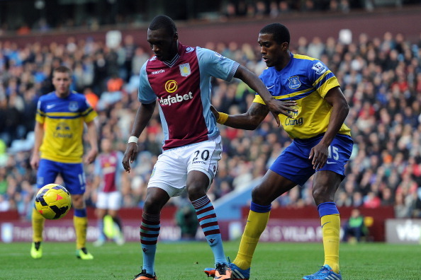 BIRMINGHAM, ENGLAND - OCTOBER 26: Christian Benteke of Aston Villa (L) holds off Sylvain Distin of Everton during the Barclays Premier League match between Aston Villa and Everton at Villa Park on October 26, 2013 in Birmingham, England. (Photo by Chris B