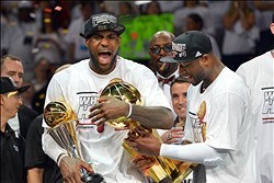 Jun 20, 2013; Miami, FL, USA; Miami Heat small forward LeBron James holds the MVP trophy and the Larry O'Brien Championship trophy after defeating the San Antonio Spurs in game seven in the 2013 NBA Finals at American Airlines Arena. Miami Heat won 95-88 