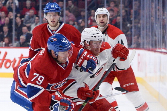 MONTREAL, QC - JANUARY 28:  Andrei Markov #79 of the Montreal Canadiens challenges Riley Nash #20 of the Carolina Hurricanes during the NHL game on January 28, 2014 at the Bell Centre in Montreal, Quebec, Canada.  (Photo by Francois Lacasse/NHLI via Getty