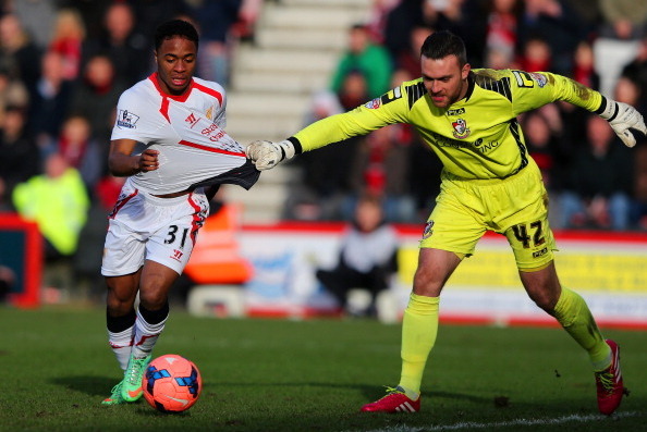 BOURNEMOUTH, ENGLAND - JANUARY 25:  Lee Camp of Bournemouth pulls on the shirt of Raheem Sterling of Liverpool during the FA Cup Fourth Round match between Bournemouth and Liverpool at Goldsands Stadium on January 25, 2014 in Bournemouth, England.  (Photo