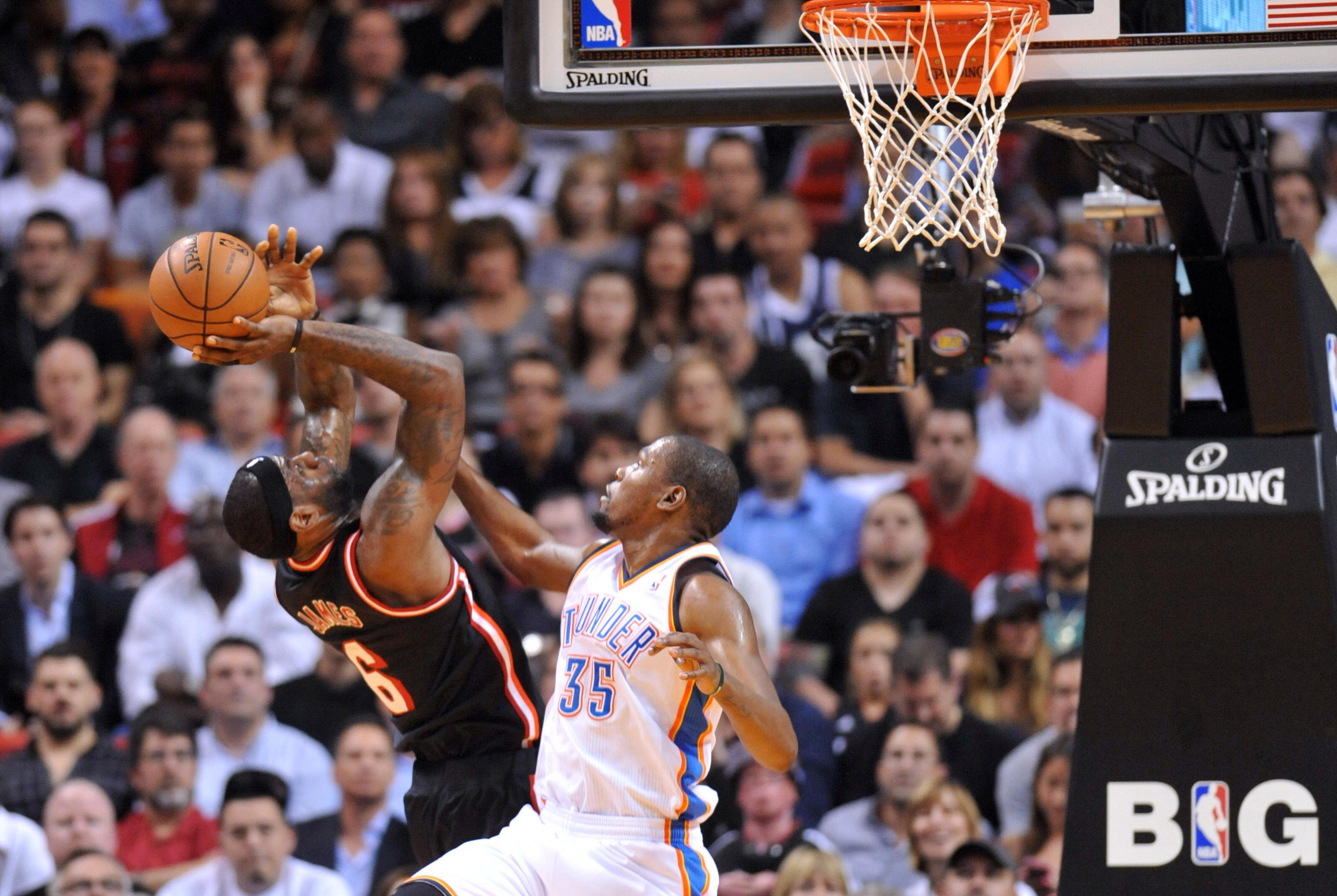 Jan 29, 2014; Miami, FL, USA; Miami Heat small forward LeBron James (6) is fouled by Oklahoma City Thunder small forward Kevin Durant (35) during the first half at American Airlines Arena. Mandatory Credit: Steve Mitchell-USA TODAY Sports