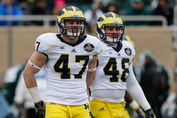 EAST LANSING, MI - NOVEMBER 02: Jake Ryan #47 and Desmond Morgan #48 of the Michigan Wolverines take a break in between plays against the Michigan State Spartans at Spartan Stadium on November 2, 2013 in East Lansing, Michigan. (Photo by Gregory Shamus/Ge