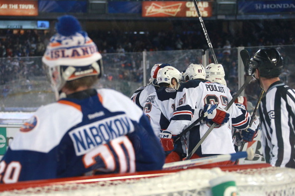 NEW YORK, NY - JANUARY 29:  (EDITORIAL USE ONLY) Benoit Pouliot #67 of the New York Rangers celebrates his second period goal with teammates Derick Brassard #16, Ryan McDonagh #27 and Mats Zuccarello #36 as goaltender Evgeni Nabokov #20 of the New York Is