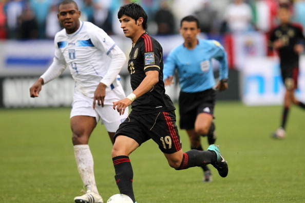 CARSON, CA - MARCH 25:  Alan Pulido #19 of Mexico controls the ball in front of Nestor Araujo #4 of Honduras during the fourth day of 2012 CONCACAF Men's Olympic Qualifying at The Home Depot Center on March 24, 2012 in Carson, California. Mexico won 3-0. 