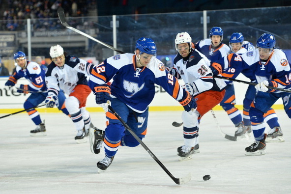 NEW YORK, NY - JANUARY 29:  (EDITORIAL USE ONLY) Josh Bailey #12 of the New York Islanders controls the puck against the New York Rangers during the 2014 Coors Light NHL Stadium Series at Yankee Stadium on January 29, 2014 in the Bronx borough of New York
