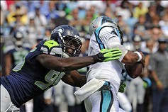 Sep 8, 2013; Charlotte, NC, USA; Seattle Seahawks defensive end Benson Mayowa (95) tries to reach Carolina Panthers quarterback Cam Newton (1) during the game at Bank of America Stadium. Sea Hawks win 12-7.  Mandatory Credit: Sam Sharpe-USA TODAY Sports