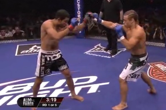 Faber checks Aldo's lead hand with his own right hand.