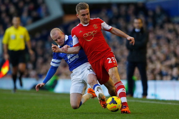 LIVERPOOL, ENGLAND - DECEMBER 29:  Luke Shaw of Southampton is tackled by Steven Naismith of Everton during the Barclays Premier League match between Everton and Southampton at Goodison Park on December 29, 2013 in Liverpool, England.  (Photo by Paul Thom