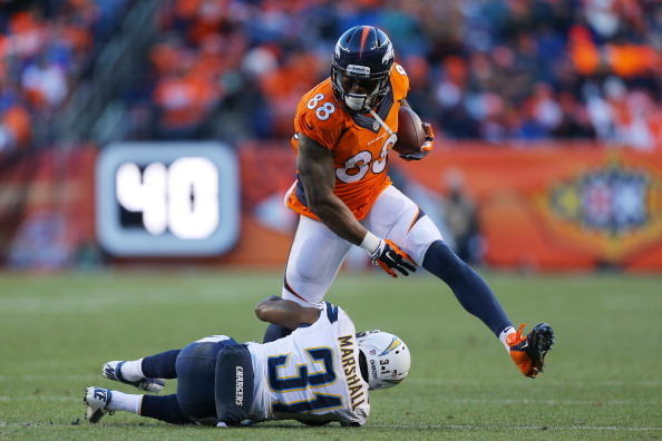 DENVER, CO - JANUARY 12:  Demaryius Thomas #88 of the Denver Broncos tries to avoid the tackle of  Richard Marshall #31 of the San Diego Chargers during the AFC Divisional Playoff Game at Sports Authority Field at Mile High on January 12, 2014 in Denver, 