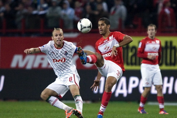 MOSCOW, RUSSIA - SEPTEMBER 02: Denis Glushakov of FC Lokomotiv Moscow (L) battles for the ball with Romulo of FC Spartak Moscow during the Russian Premier League match between FC Lokomotiv Moscow and FC Spartak Moscow at Lokomotiv Stadium on September 02,