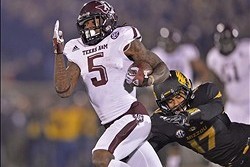Nov 30, 2013; Columbia, MO, USA; Texas A&M Aggies running back Brandon Williams (5) rushes up field past Missouri Tigers safety Matt White (17) during the first half at Faurot Field. Mandatory Credit: Peter G. Aiken-USA TODAY Sports