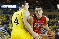 Dec 14, 2013; Ann Arbor, MI, USA; Arizona Wildcats forward Aaron Gordon (11) is defended by Michigan Wolverines forward Mitch McGary (4) in the second half at Crisler Center. Arizona won 72-70. Mandatory Credit: Rick Osentoski-USA TODAY Sports