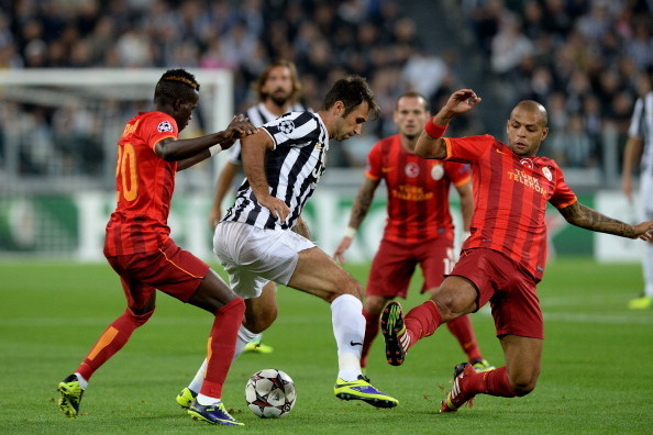 TURIN, ITALY - OCTOBER 02:  Mirko Vucinic of Juventus and Felipe Melo of Galatasaray AS (R) compete for the ball during UEFA Champions League Group B match between Juventus and Galatasaray AS at Juventus Arena on October 2, 2013 in Turin, Italy.  (Photo b