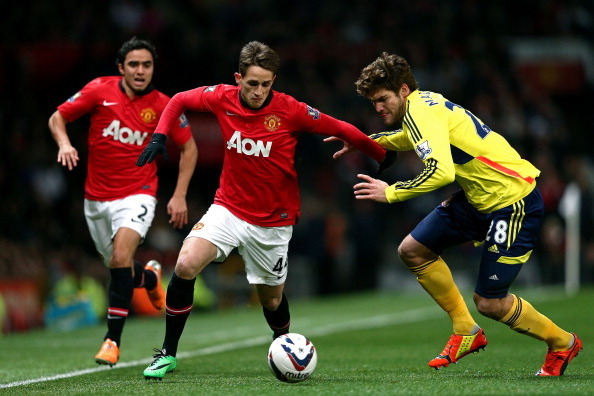 MANCHESTER, ENGLAND - JANUARY 22:  Adnan Januzaj of Manchester United is challenged by Marcos Alonso of Sunderland during the Capital One Cup semi final, second leg match between Manchester United and Sunderland at Old Trafford on January 22, 2014 in Manc