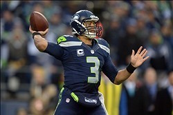 Jan 19, 2014; Seattle, WA, USA; Seattle Seahawks quarterback Russell Wilson (3) drops back to pass against the San Francisco 49ers during the first half of the 2013 NFC Championship football game at CenturyLink Field. Mandatory Credit: Kirby Lee-USA TODAY