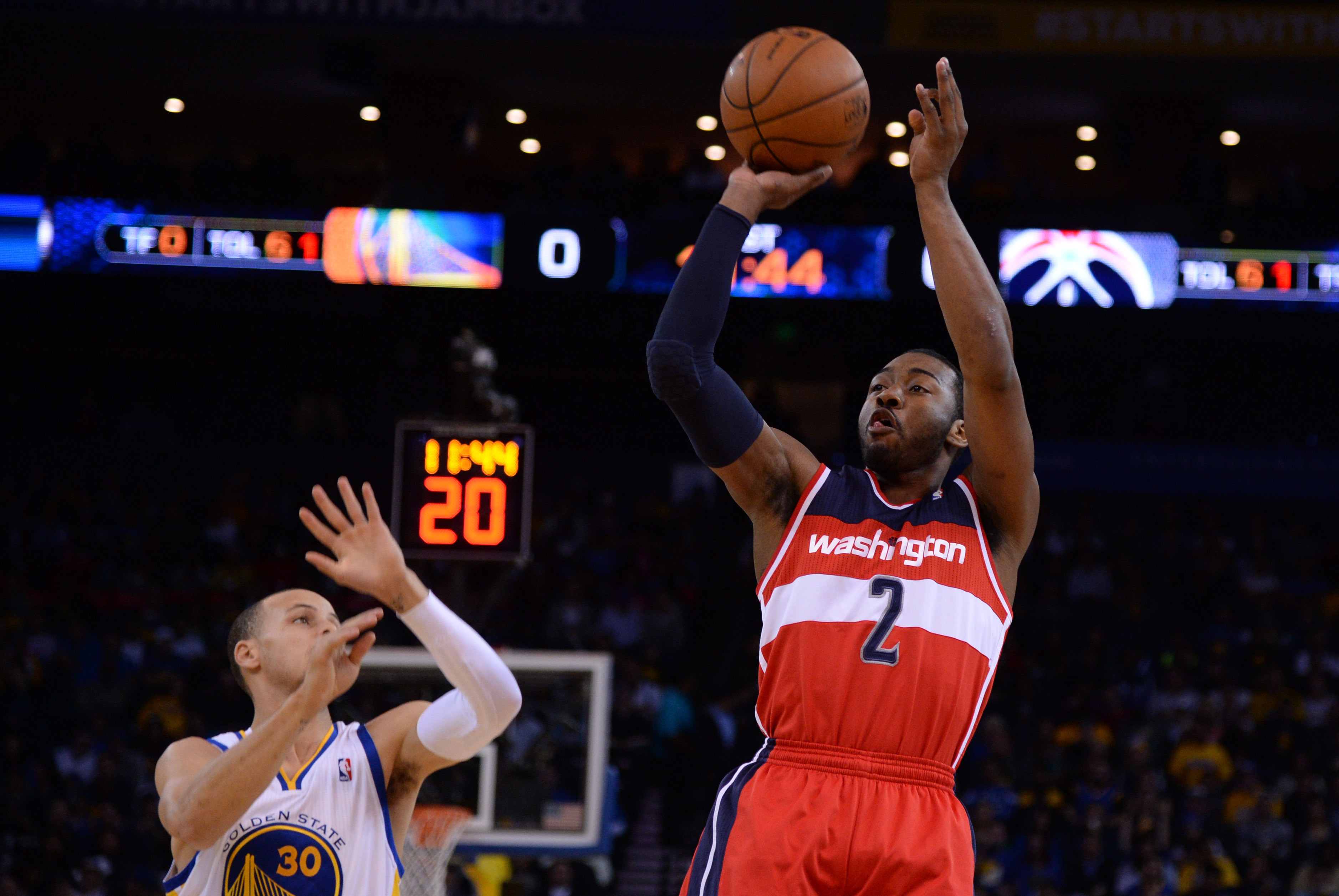 January 28, 2014; Oakland, CA, USA; Washington Wizards point guard John Wall (2) shoots the ball against Golden State Warriors point guard Stephen Curry (30) during the first quarter at Oracle Arena. Mandatory Credit: Kyle Terada-USA TODAY Sports