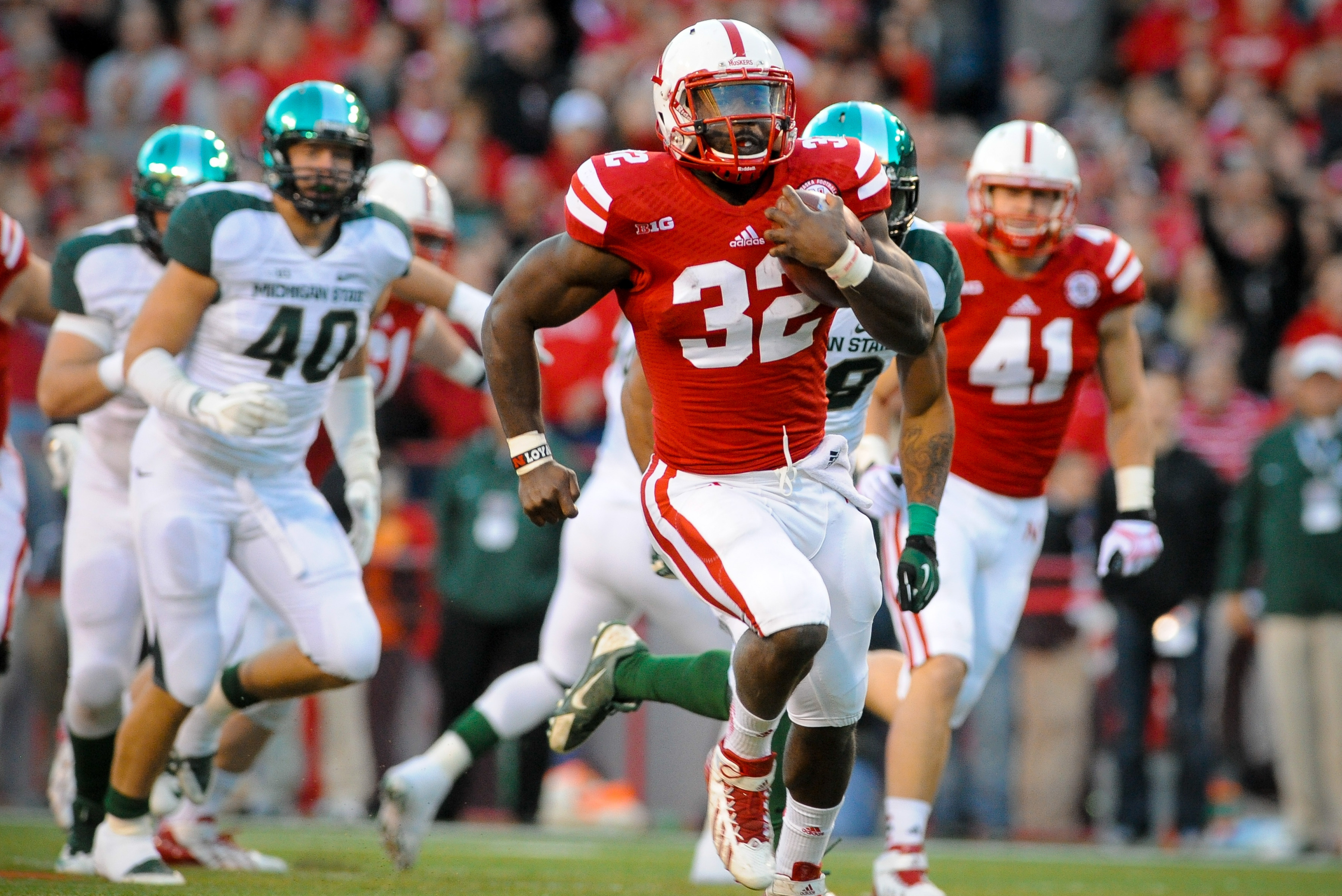 LINCOLN, NE - NOVEMBER 16: Running back Imani Cross #32 of the Nebraska Cornhuskers runs for a touchdown during their game against the Michigan State Spartans at Memorial Stadium on November 16, 2013 in Lincoln, Nebraska. (Photo by Eric Francis/Getty Imag