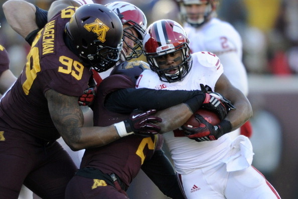 MINNEAPOLIS, MN - NOVEMBER 23: Ra'Shede Hageman #99 and Cedric Thompson #2 of the Minnesota Golden Gophers tackle James White #20 of the Wisconsin Badgers during the first quarter of the game on November 23, 2013 at TCF Bank Stadium in Minneapolis, Minnes