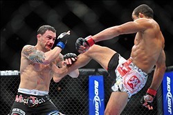 Feb 2, 2013; Las Vegas, NV, USA; Jose Aldo (right) push kicks Frankie Edgar (left) during UFC 156 at the Mandalay Bay Events Center. Mandatory Credit: Gary A. Vasquez-USA TODAY Sports