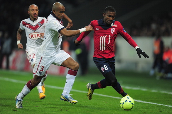 LILLE, FRANCE - MARCH 03:  Dit Henrique of Bordeaux battles with Salomon Kalou of Lille during the Ligue 1 match between LOSC Lille Metropole v FC Girondins de Bordeaux at the Grand Stade Lille-Metropole on March 3, 2013 in Lille, France.  (Photo by Jamie