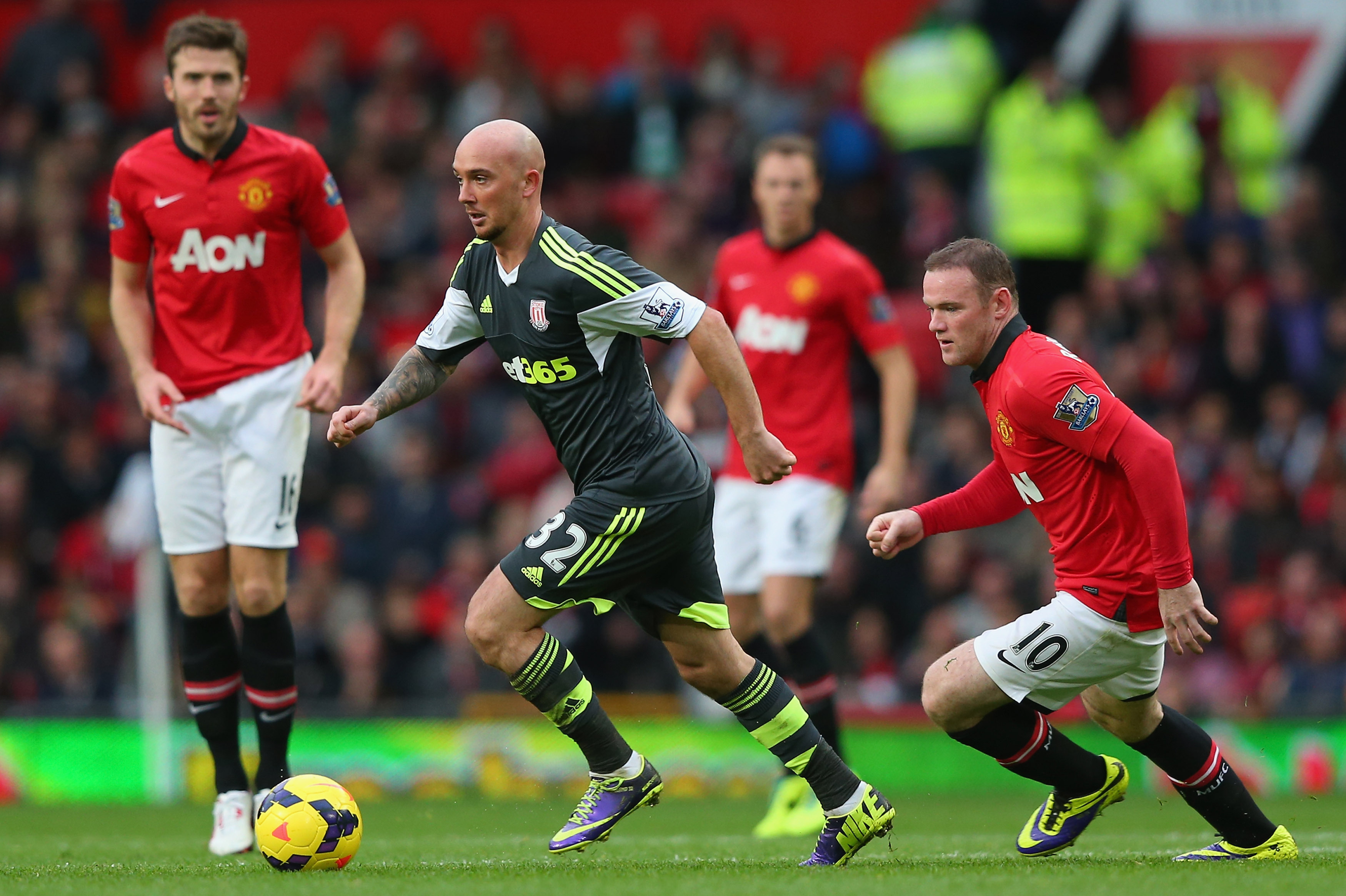 MANCHESTER, ENGLAND - OCTOBER 26:  Stephen Ireland of Stoke City beats Wayne Rooney of Manchester United during the Barclays Premier League match between Manchester United and Stoke City at Old Trafford on October 26, 2013 in Manchester, England.  (Photo