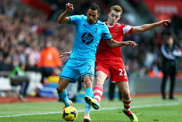 SOUTHAMPTON, ENGLAND - DECEMBER 22:  Nacer Chadli of Spurs holds off the challenge from Calum Chambers of Southampton during the Barclays Premier League match between Southampton and Tottenham Hotspur at St Mary's Stadium on December 22, 2013 in Southampt
