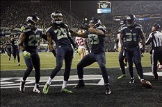 Jan 19, 2014; Seattle, WA, USA; (EDITORS NOTE: caption correction) Seattle Seahawks cornerback Richard Sherman (25) celebrates after tipping a pass to outside linebacker Malcolm Smith (53) for an interception in the fourth quarter of the 2013 NFC Champion