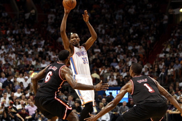 MIAMI, FL - JANUARY 29:  Forward Kevin Durant #35 of the Oklahoma City Thunder is defended by  Forward LeBron James #6 and Chris Bosh #1 of the Miami Heat at AmericanAirlines Arena on January 29, 2014 in Miami, Florida. The Thunder defeated the Heat 112-9