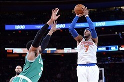 Jan 28, 2014; New York, NY, USA; New York Knicks small forward Carmelo Anthony (7) shoots over Boston Celtics center Jared Sullinger (7) during the second half at Madison Square Garden. The New York Knicks won the game 114-88. Mandatory Credit: Joe Campor