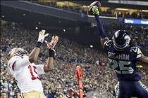 Jan 19, 2014; Seattle, WA, USA; Seattle Seahawks cornerback Richard Sherman (25) tips a pass intended for San Francisco 49ers wide receiver Michael Crabtree (15) that is intercepted by Seahawks outside linebacker Malcolm Smith (not pictured) in the fourth