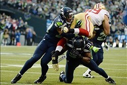 Jan 19, 2014; Seattle, WA, USA; San Francisco 49ers tight end Vance McDonald (89) is tackled by Seattle Seahawks middle linebacker Bobby Wagner (54) and strong safety Kam Chancellor (31) during the first half of the 2013 NFC Championship football game at