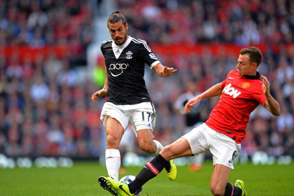 MANCHESTER, ENGLAND - OCTOBER 19:  Daniel Osvaldo of Southampton is tackled by Jonny Evans of Manchester United during the Barclays Premier League match between Manchester United and Southampton at Old Trafford on October 19, 2013 in Manchester, England. 