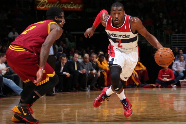 WASHINGTON, DC - NOVEMBER 16: John Wall #2 of the Washington Wizards drives against Kyrie Irving #2 of the Cleveland Cavaliers during the game at the Verizon Center on November 16, 2013 in Washington, DC. NOTE TO USER: User expressly acknowledges and agre