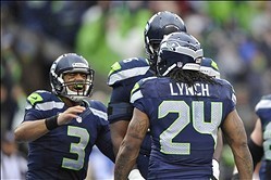 Jan 11, 2014; Seattle, WA, USA; Seattle Seahawks quarterback Russell Wilson (3) congratulates running back Marshawn Lynch (24) for scoring a touchdown against the New Orleans Saints during the first half of the 2013 NFC divisional playoff football game at