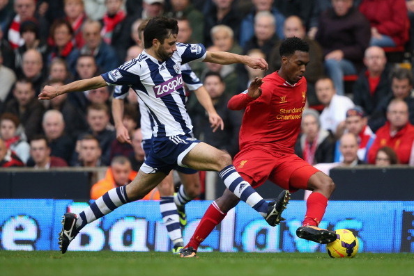 LIVERPOOL, ENGLAND - OCTOBER 26:  Daniel Sturridge of Liverpool competes with Claudio Yacob of West Bromwich Albion during the Barclays Premier League match between Liverpool and West Bromwich Albion at Anfield on October 26, 2013 in Liverpool, England.  