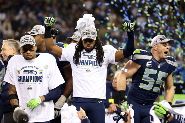 SEATTLE, WA - JANUARY 19:  Cornerback Richard Sherman #25 of the Seattle Seahawks celebrates on the field after the Seahawks defeat the San Francisco 49ers 23-17 in the 2014 NFC Championship at CenturyLink Field on January 19, 2014 in Seattle, Washington.