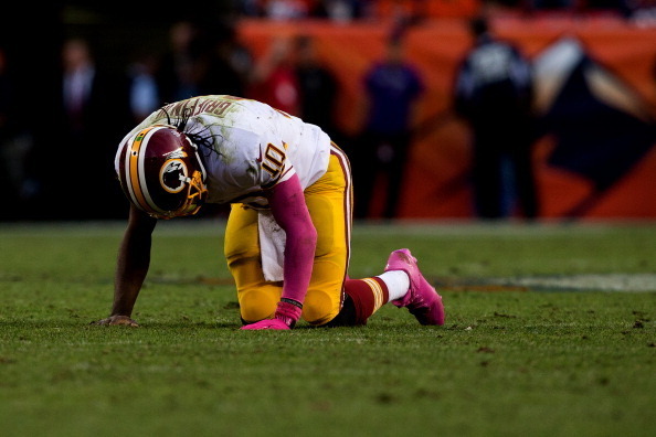 DENVER, CO - OCTOBER 27:  Quarterback Robert Griffin III #10 of the Washington Redskins goes to his knees after throwing an interception during the fourth quarter against the Denver Broncos at Sports Authority Field Field at Mile High on October 27, 2013
