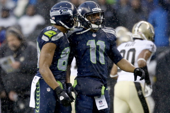 SEATTLE, WA - JANUARY 11:  Wide receiver Doug Baldwin #89 and wide receiver Percy Harvin #11 of the Seattle Seahawks talk in the second quarter against the New Orleans Saints during the NFC Divisional Playoff Game at CenturyLink Field on January 11, 2014 