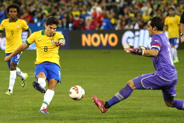 TORONTO, ON - NOVEMBER 19:  Hernanes #8 of Brazil tries to get a shot past Claudio Bravo #1 of Chile during a friendly match at Rogers Centre on November 19, 2013 in Toronto, Canada.Brazil defeated Chile 2-1.  (Photo by Elsa/Getty Images)