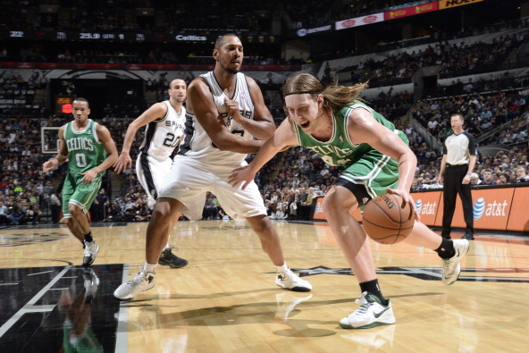 SAN ANTONIO, TX - November 20: Kelly Olynyk #41 of the Boston Celtics drives to the basket against Boris Diaw #33 of the San Antonio Spurs at the AT&T Center on November 20, 2013 in San Antonio, Texas. NOTE TO USER: User expressly acknowledges and agrees 