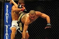 Jul 21, 2012; Calgary, AB, CANADA; Renan Barao (blue golves) and Urijah Faber (red gloves) during the interim bantamweight title bout of UFC 149 at the Scotiabank Saddledome. Mandatory Credit: Anne-Marie Sorvin-USA TODAY Sports