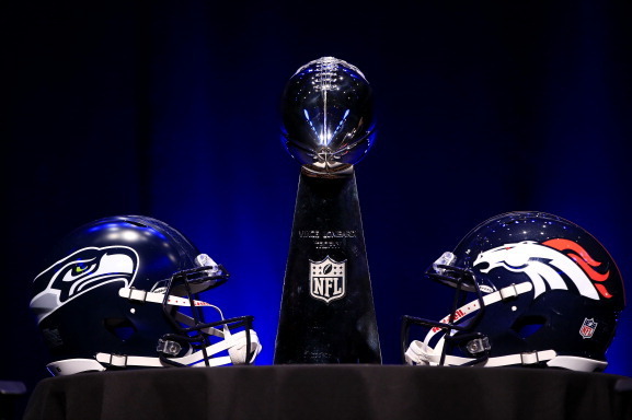 NEW YORK, NY - JANUARY 31:  The Vince Lombardi Trophy and helmets for the Denver Broncos and the Seattle Seahawks are displayed prior to a Super Bowl XLVIII head coach joint press conference at the Rose Theater in Jazz at Lincoln Center on January 31, 201