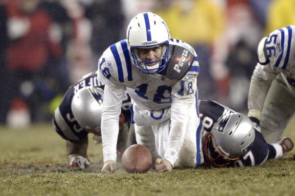 FOXBORO, MA - JANUARY 18:  Quarterback Peyton Manning #18 of the Indianapolis Colts gets up after being sacked by Jarvis Green #97 and Roman Phifer #95 of the New England Patriots in the AFC Championship Game on January 18, 2004 at Gillette Stadium in Fox