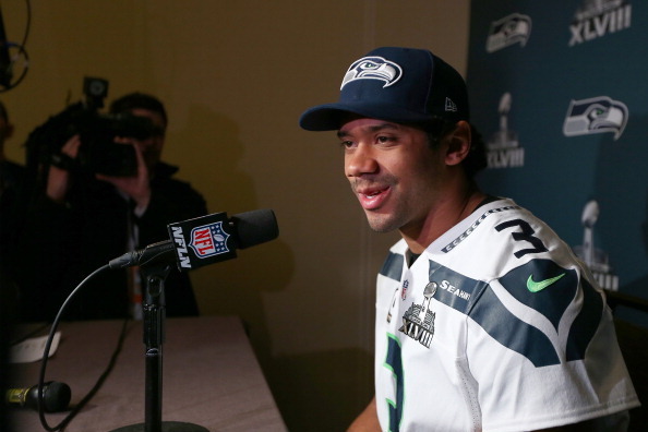 JERSEY CITY, NJ - JANUARY 30:  Russell Wilson #3 of the Seattle Seahawks addresses the media during Super Bowl XLVIII media availability at the Westin Hotel January 30, 2014 in Jersey City, New Jersey. The Denver Broncos and Seattle Seahawks will meet in 
