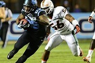 Oct 17, 2013; Chapel Hill, NC, USA; North Carolina Tar Heels tight end Eric Ebron (85) runs for a touchdown as Miami Hurricanes linebacker Raphael Kirby (56) defends in the first quarter at Kenan Memorial Stadium. Mandatory Credit: Bob Donnan-USA TODAY Sp
