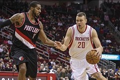 Jan 20, 2014; Houston, TX, USA; Houston Rockets power forward Donatas Motiejunas (20) drives to the basket during the first quarter as Portland Trail Blazers power forward LaMarcus Aldridge (12) defends at Toyota Center. Mandatory Credit: Troy Taormina-US