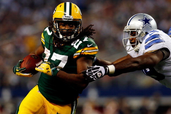 ARLINGTON, TX - DECEMBER 15:  Running back Eddie Lacy #27 of the Green Bay Packers runs with the ball as defensive end George Selvie #99 of the Dallas Cowboys defends during a game at AT&T Stadium on December 15, 2013 in Arlington, Texas.  (Photo by Tom P