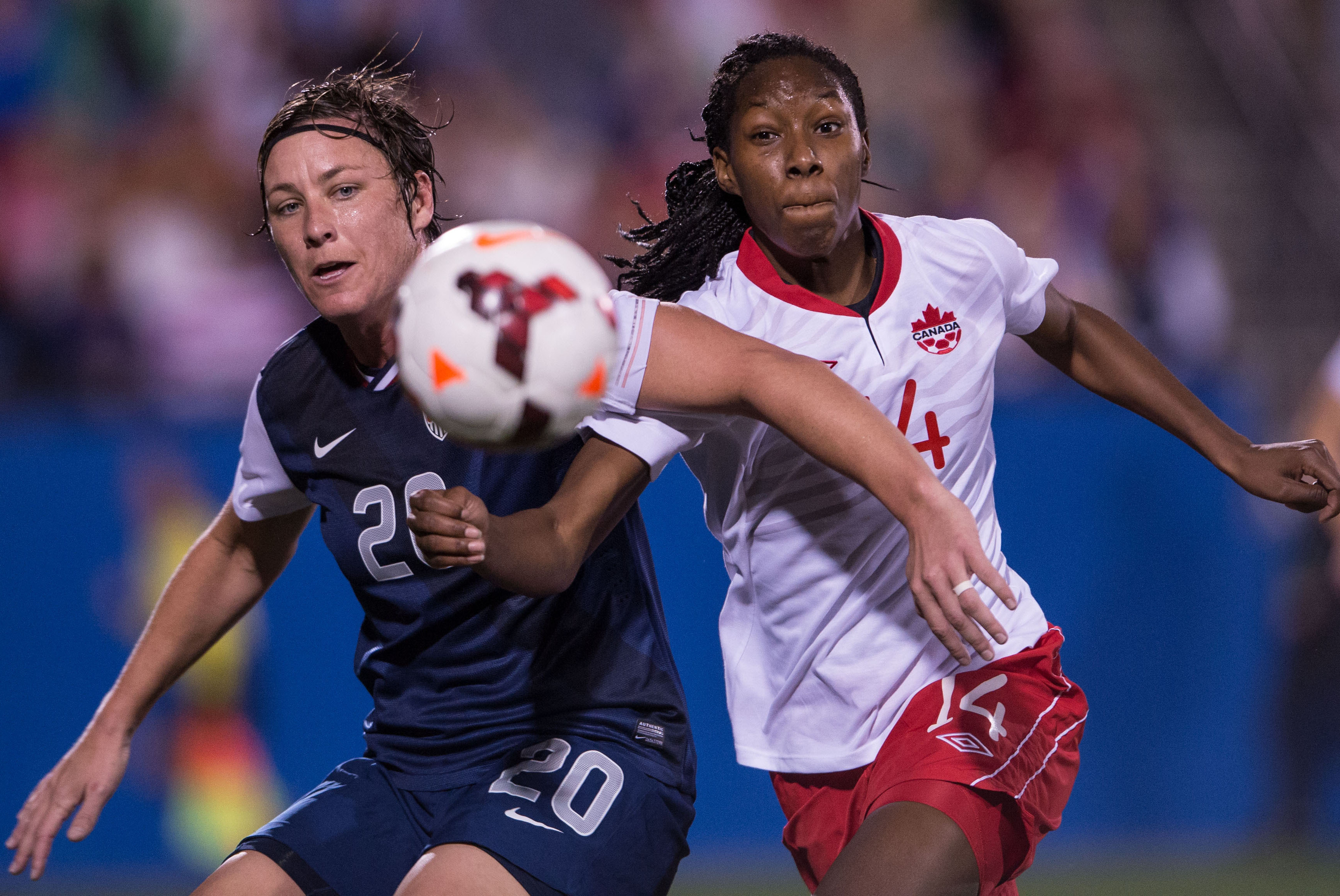 Jan 31, 2014; Frisco, TX, USA; USA forward Abby Wambach (20) battles for the ball with Canada defender Kadeisha Buchanan (14) during the first half at Toyota Stadium. Mandatory Credit: Jerome Miron-USA TODAY Sports