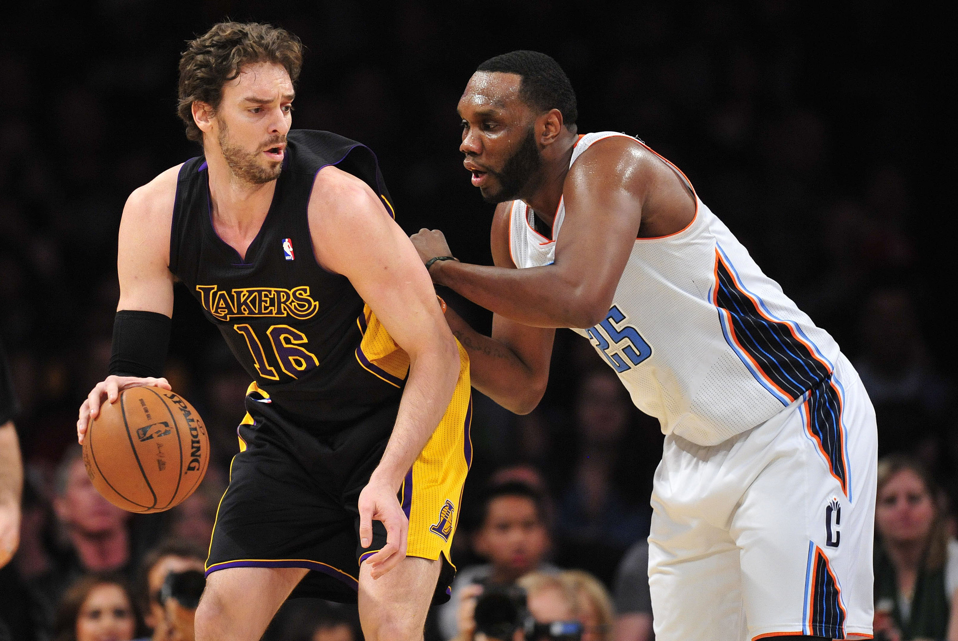 January 31, 2014; Los Angeles, CA, USA; Los Angeles Lakers center Pau Gasol (16) moves the ball against the defense of Charlotte Bobcats center Al Jefferson (25) during the first half at Staples Center. Mandatory Credit: Gary A. Vasquez-USA TODAY Sports