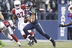 Dec 22, 2013; Seattle, WA, USA; Seattle Seahawks wide receiver Doug Baldwin (89) returns a kick against the Arizona Cardinals during the fourth quarter at CenturyLink Field. Mandatory Credit: Joe Nicholson-USA TODAY Sports